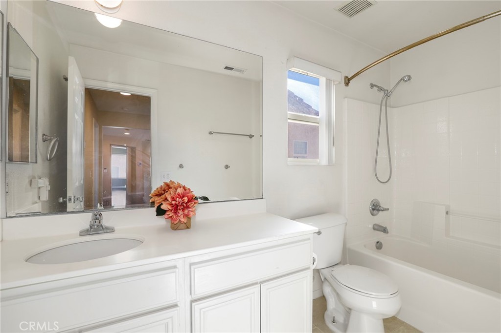 3437 Nature Trail Court Perris, CA 92571 - Photo 39 of 49 a bathroom with a sink toilet vanity and shower