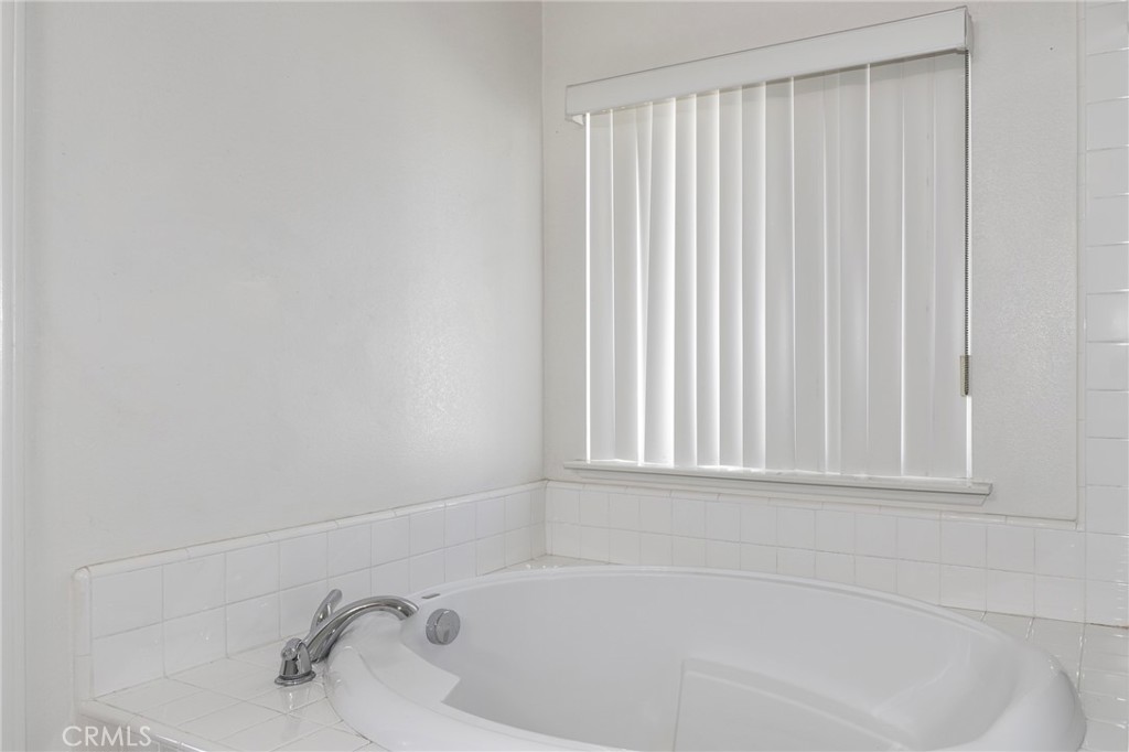 3437 Nature Trail Court Perris, CA 92571 - Photo 40 of 49 a white bath tub sitting in a bathroom