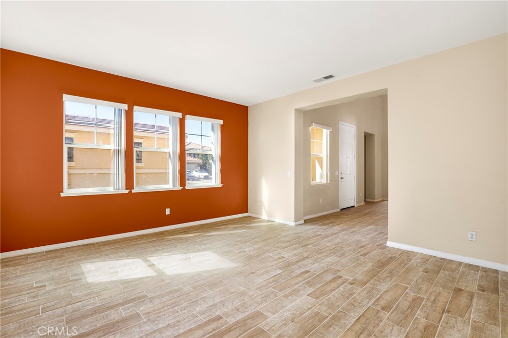 3437 Nature Trail Court Perris, CA 92571 - Photo 10 of 49 a view of an empty room with wooden floor and a window