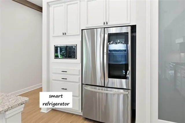 a view of kitchen with refrigerator and window