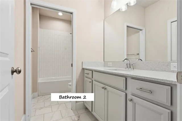 a bathroom with a sink toilet and a mirror