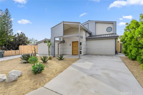 a view of a house with a yard and plants