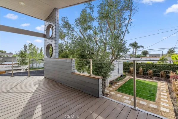 a view of a deck with couches and wooden floor