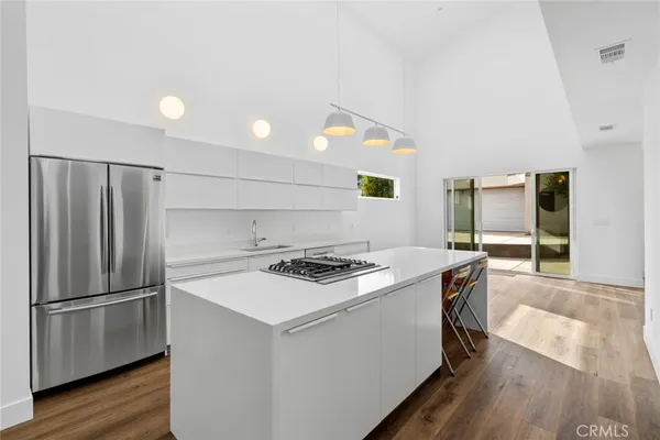 a kitchen with a stove a sink and a refrigerator