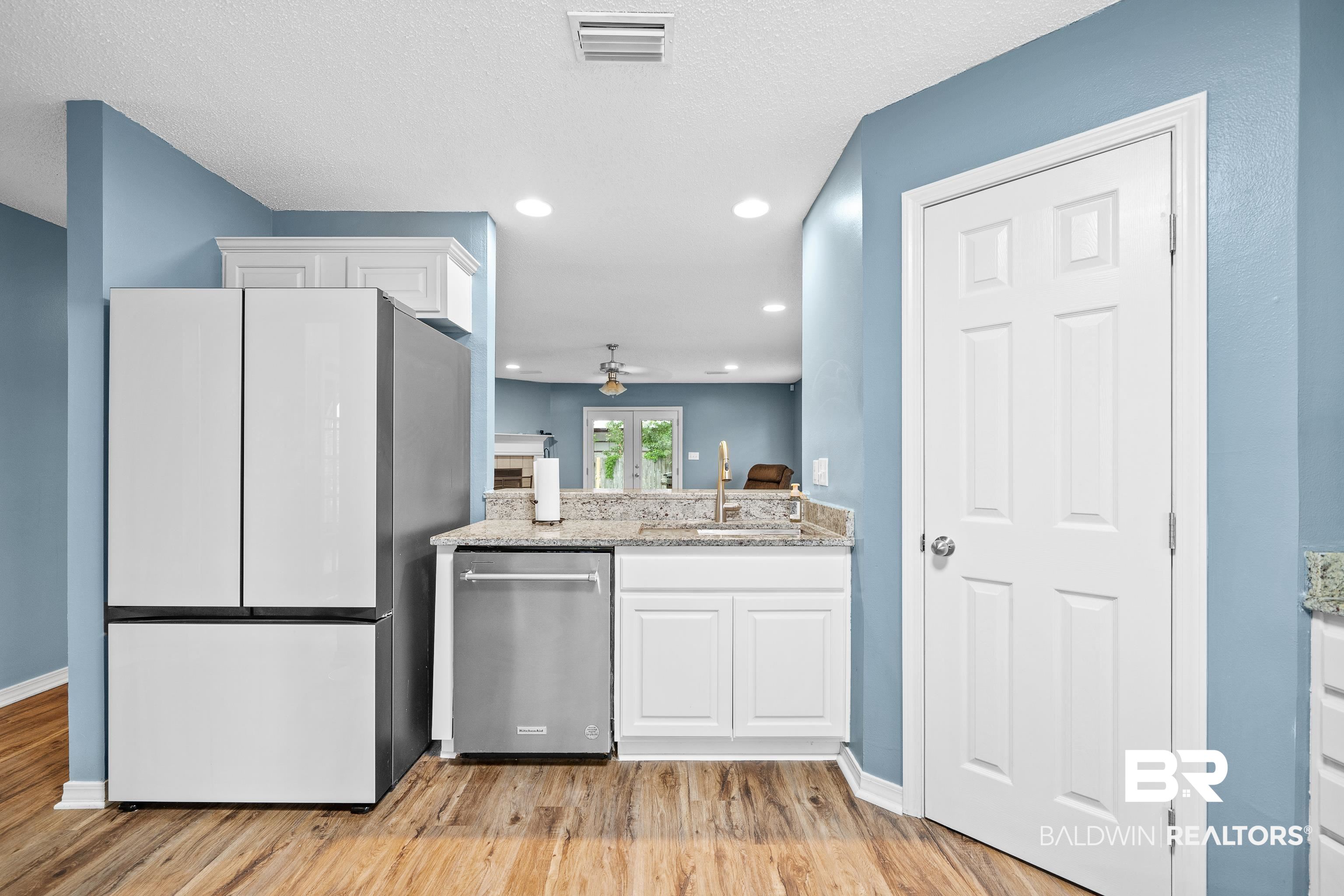 9552 Collier Loop Daphne, AL 36526 - Photo 8 of 28 Kitchen featuring freestanding refrigerator, a sink, stainless steel dishwasher, ceiling fan, and light wood-type flooring