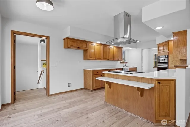 a kitchen with stainless steel appliances a stove top oven and refrigerator