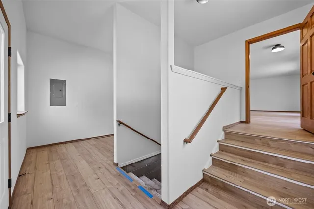 a view of entryway with wooden floor and stairs