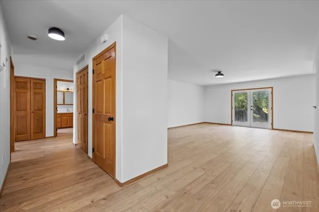 a view of empty room with wooden floor