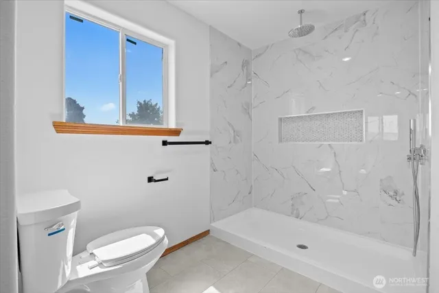 a bathroom with a toilet a sink and bathtub