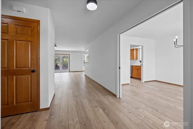 a view of a hallway with wooden floor