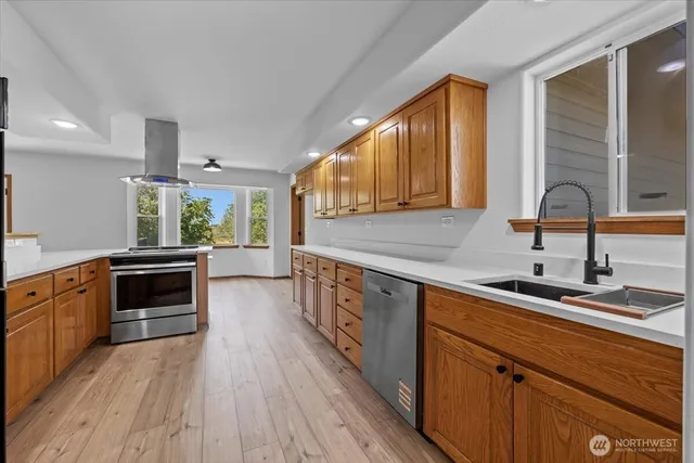 a kitchen with stainless steel appliances a stove sink and cabinets