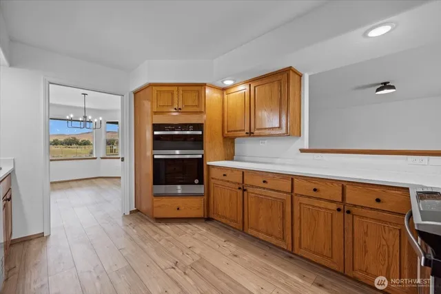 a kitchen with wooden floors and cabinets