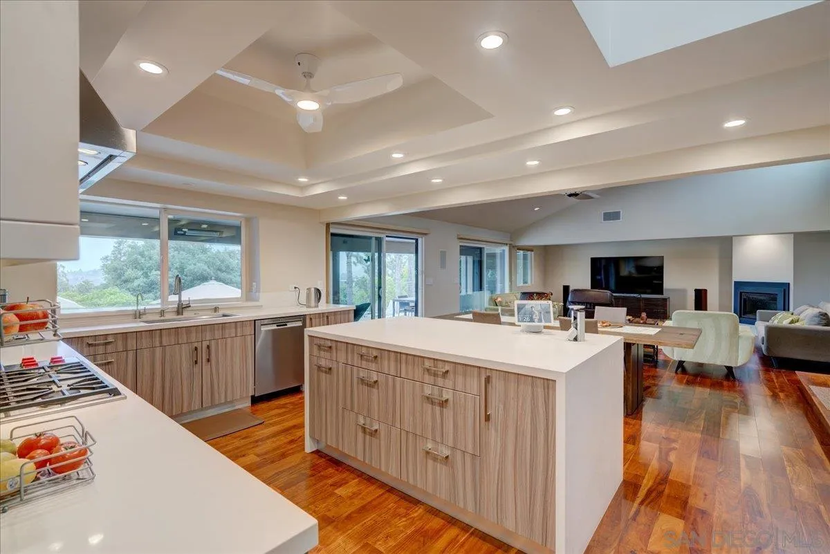 16117 Martincoit Road Poway, CA 92064 - Photo 12 of 50 a large kitchen with stainless steel appliances a stove a sink dishwasher and a refrigerator with wooden floor