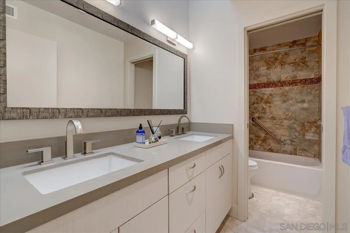 16117 Martincoit Road Poway, CA 92064 - Photo 18 of 50 a bathroom with a double vanity sink and a mirror