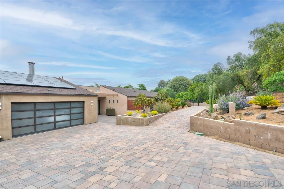 16117 Martincoit Road Poway, CA 92064 - Photo 3 of 50 a view of a house with a backyard and a garage