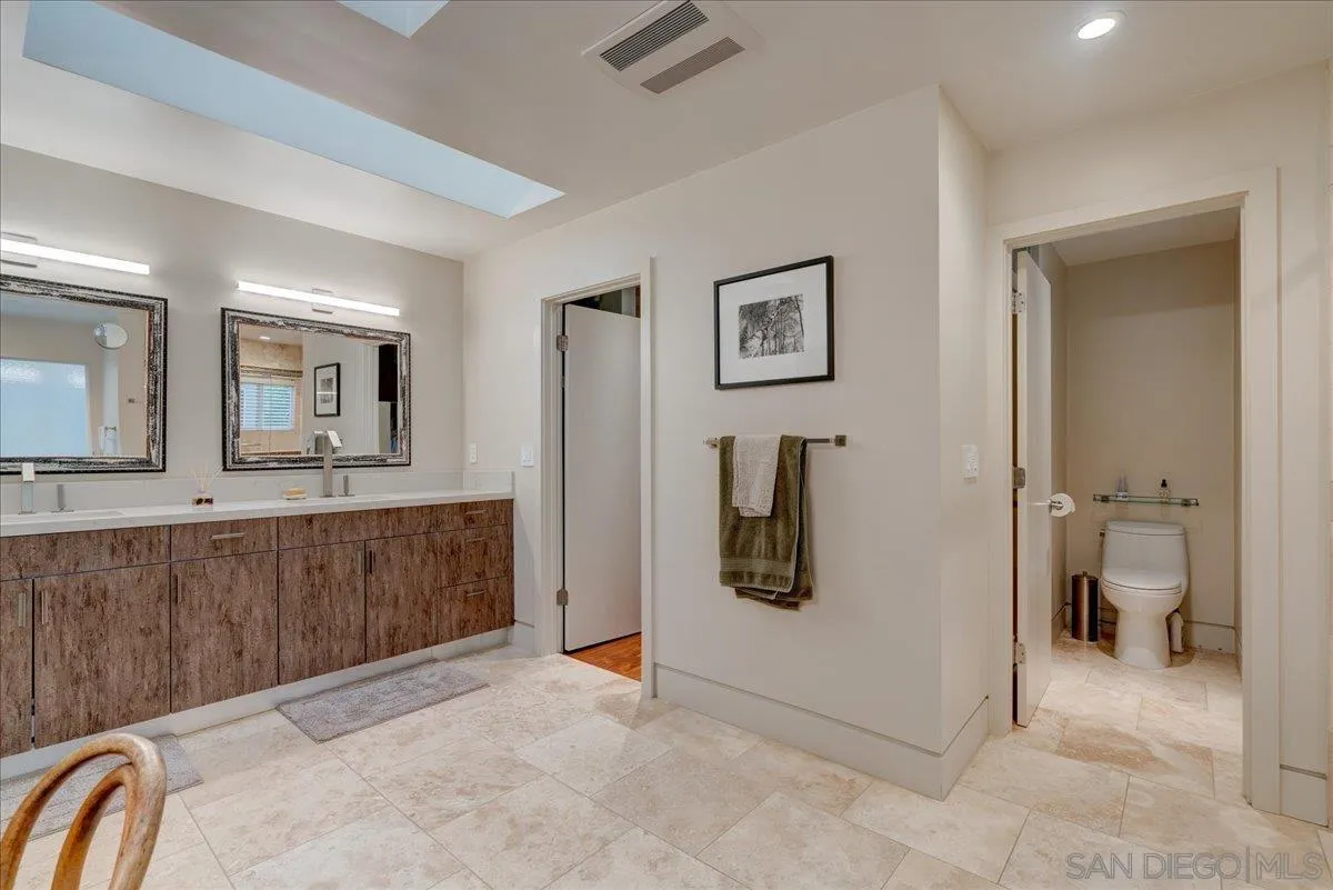 16117 Martincoit Road Poway, CA 92064 - Photo 32 of 50 a view of a bathroom with sink mirror and toilet