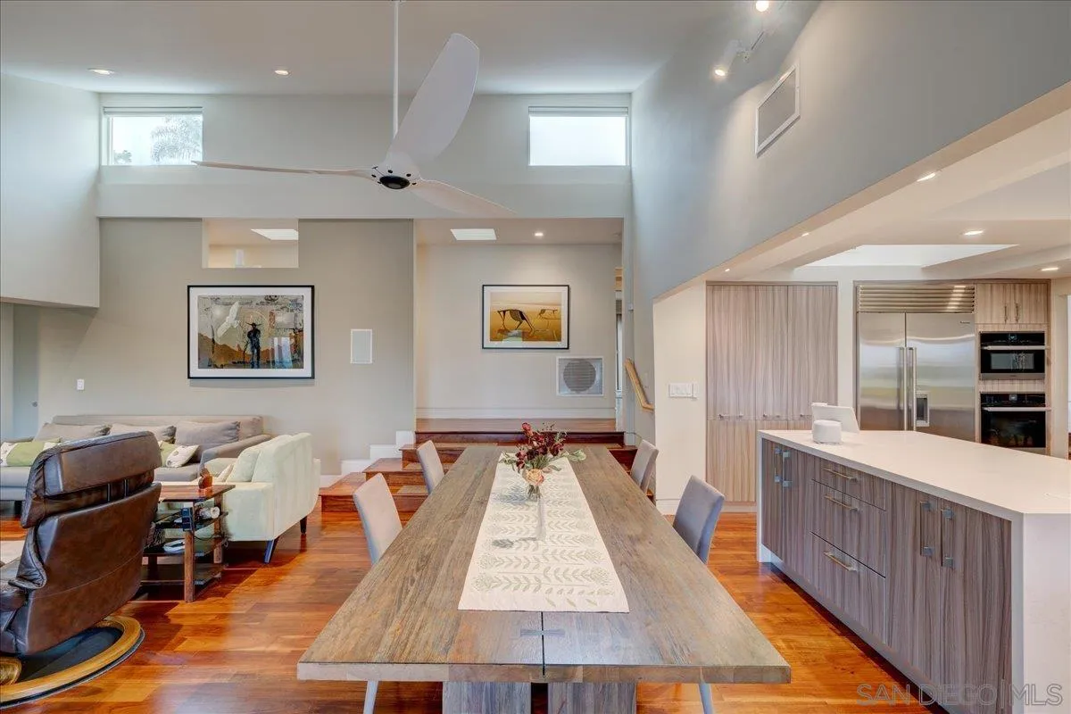 16117 Martincoit Road Poway, CA 92064 - Photo 8 of 50 a large room with kitchen island a large counter top space and wooden floor
