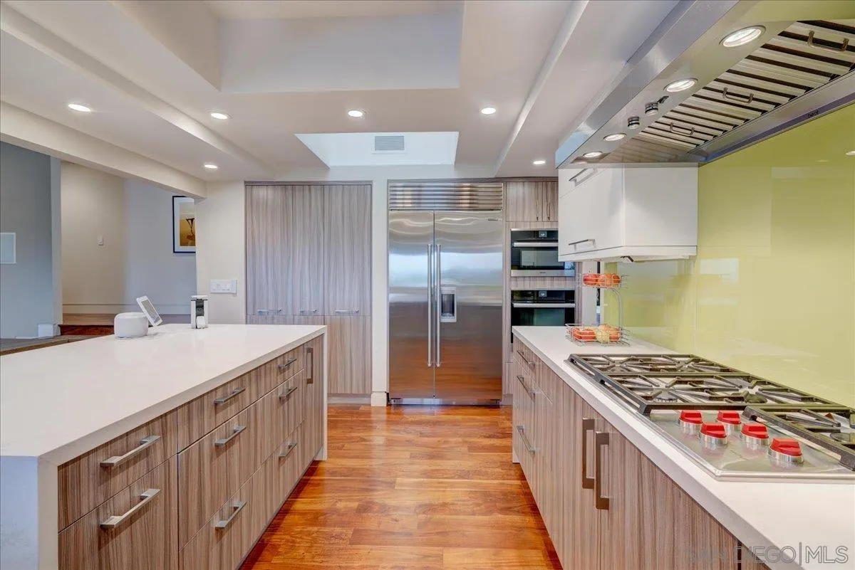 16117 Martincoit Road Poway, CA 92064 - Photo 9 of 50 a kitchen with kitchen island stainless steel appliances a sink and stove