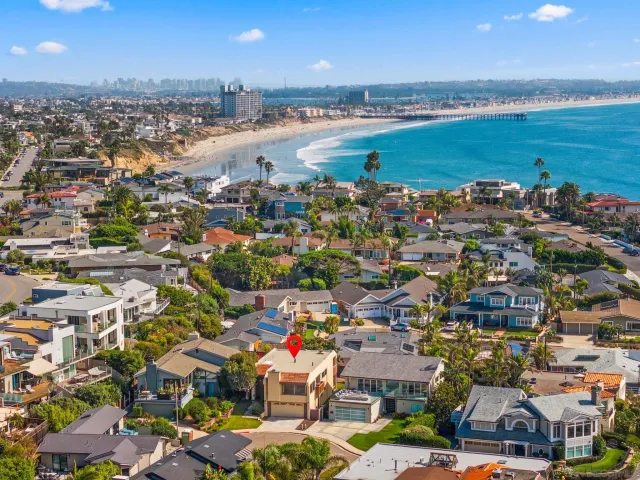 an aerial view of a building with outdoor space and ocean view
