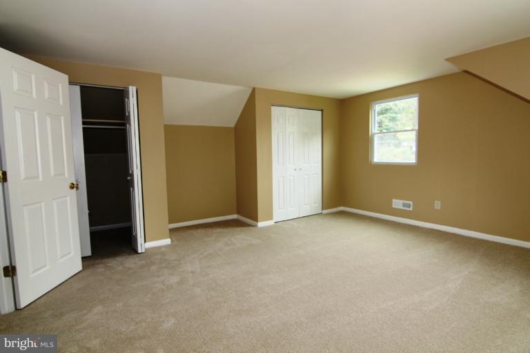 9114 Samoset Road Randallstown, MD 21133 - Photo 12 of 13 an empty room with windows and closet