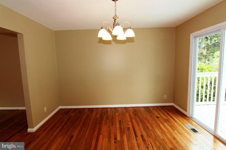 9114 Samoset Road Randallstown, MD 21133 - Photo 3 of 13 a view of room with window and wooden floor