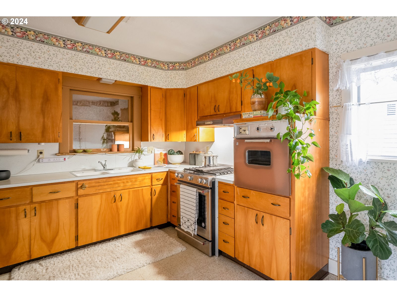 5232 Southeast Raymond Street Portland, OR 97206 - Photo 12 of 39 a kitchen with stainless steel appliances granite countertop a stove a sink and a microwave