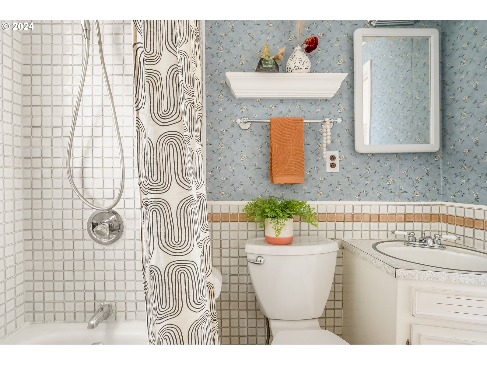 5232 Southeast Raymond Street Portland, OR 97206 - Photo 18 of 39 a bathroom with a sink a mirror and a shower