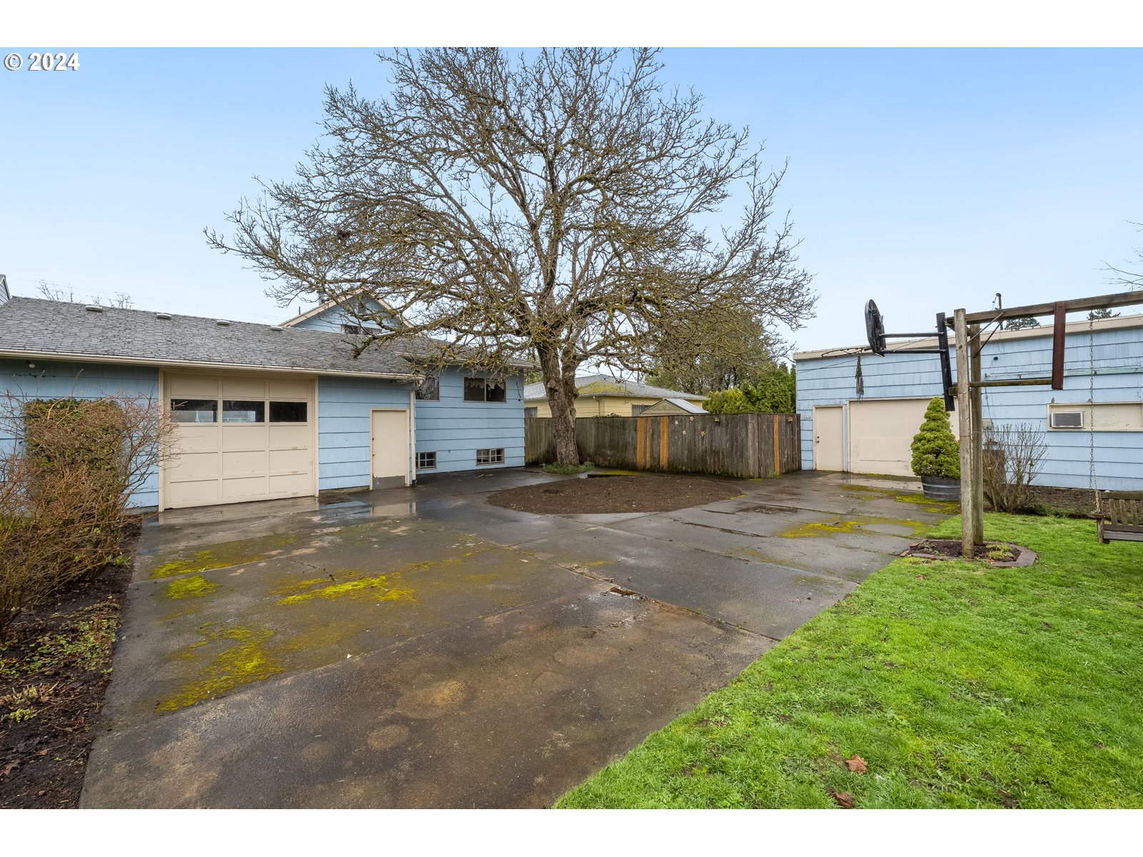 5232 Southeast Raymond Street Portland, OR 97206 - Photo 36 of 39 a view of a yard with a house and a large tree