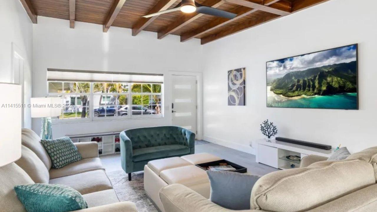8926 Abbott Avenue Surfside, FL 33154 - Photo 2 of 5 a living room with furniture and a large window