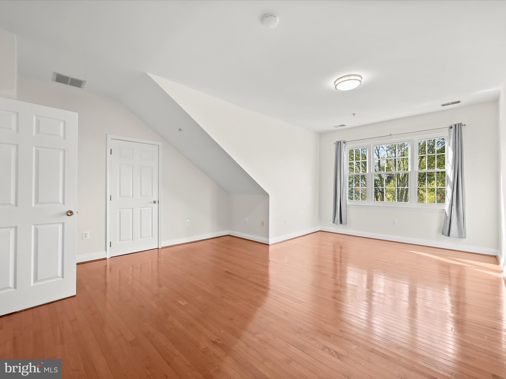 2711 Middle Neck Road Odenton, MD 21113 - Photo 23 of 42 a view of an empty room with wooden floor and a window