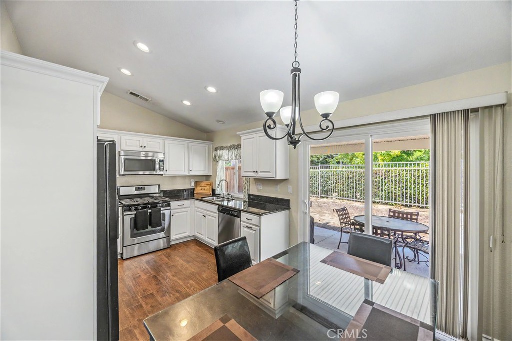 43121 Corte Cabrera Temecula, CA 92592 - Photo 2 of 17 a view of a dining room and livingroom with furniture wooden floor a chandelier