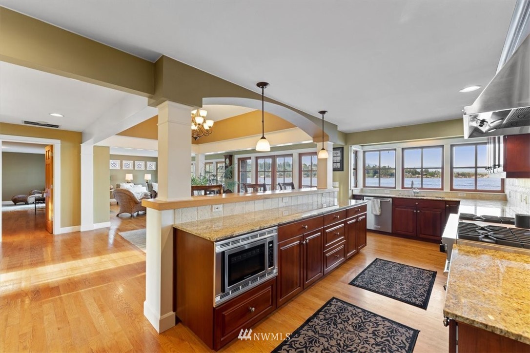 1707 Vernon Road Lake Stevens, WA 98258 - Photo 12 of 40 a kitchen with stainless steel appliances granite countertop a stove and a wooden cabinets