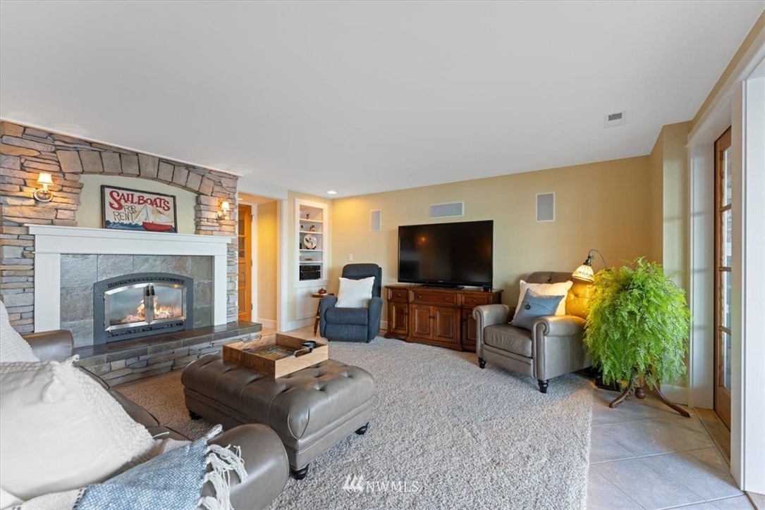 1707 Vernon Road Lake Stevens, WA 98258 - Photo 24 of 40 a living room with furniture a flat screen tv and a fireplace