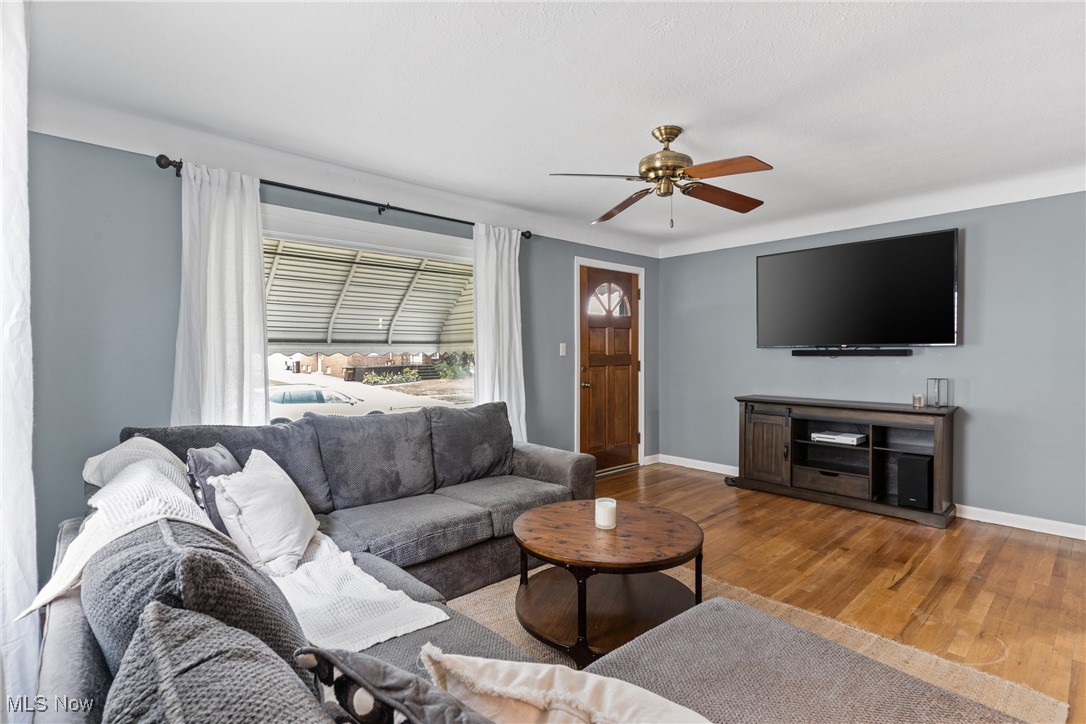 7514 Spring Garden Road Cleveland, OH 44129 - Photo 6 of 30 Living area with light hardwood finished floors and a ceiling fan