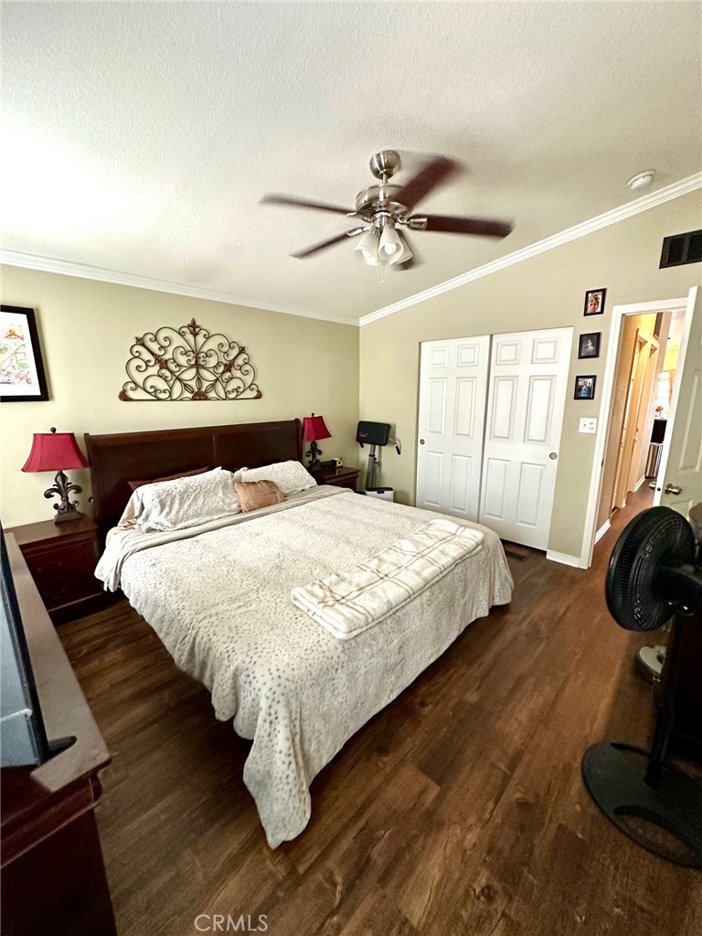 30000 Hasley Canyon Road, Unit 9 Valencia, CA 91384 - Photo 14 of 26 Primary bedroom with fan and crown molding