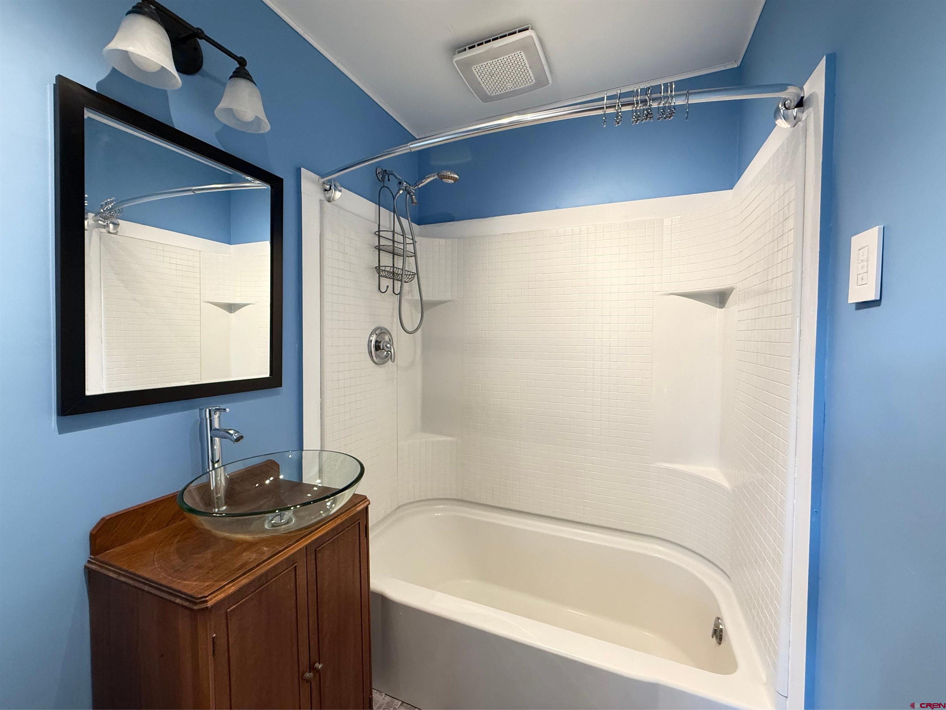 458 Price Road Paonia, CO 81428 - Photo 26 of 44 a bathroom with a bathtub sink vanity and mirror