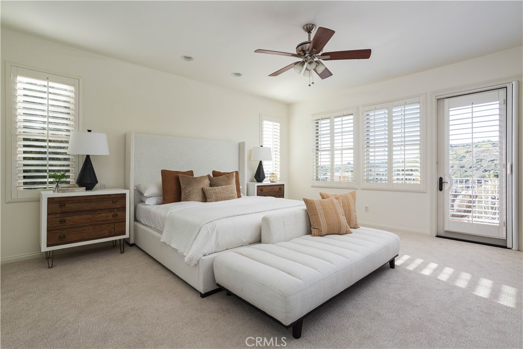 16 Via Elda San Clemente, CA 92673 - Photo 18 of 32 a bedroom with a bed a dresser and a chandelier