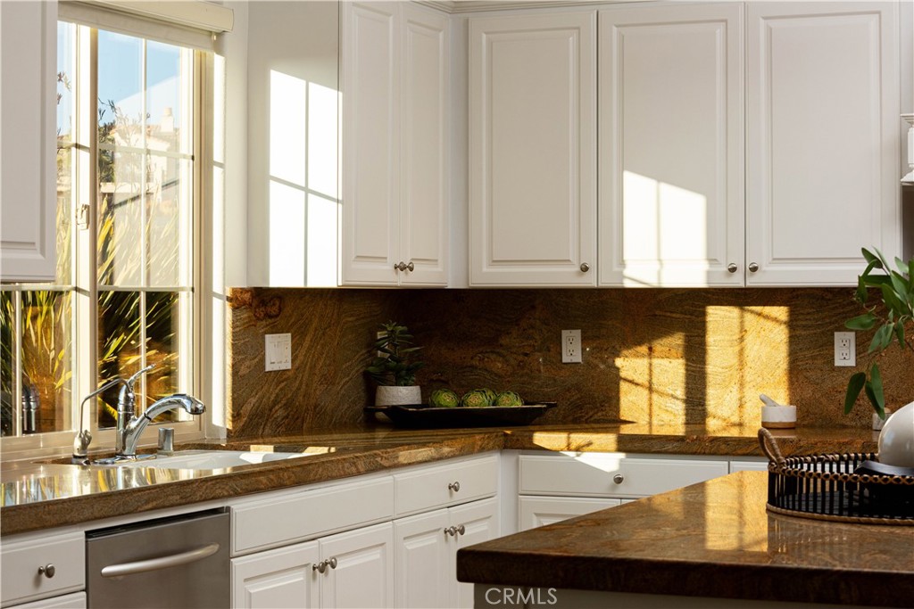 16 Via Elda San Clemente, CA 92673 - Photo 6 of 32 a kitchen with granite countertop a sink and a white wooden cabinets
