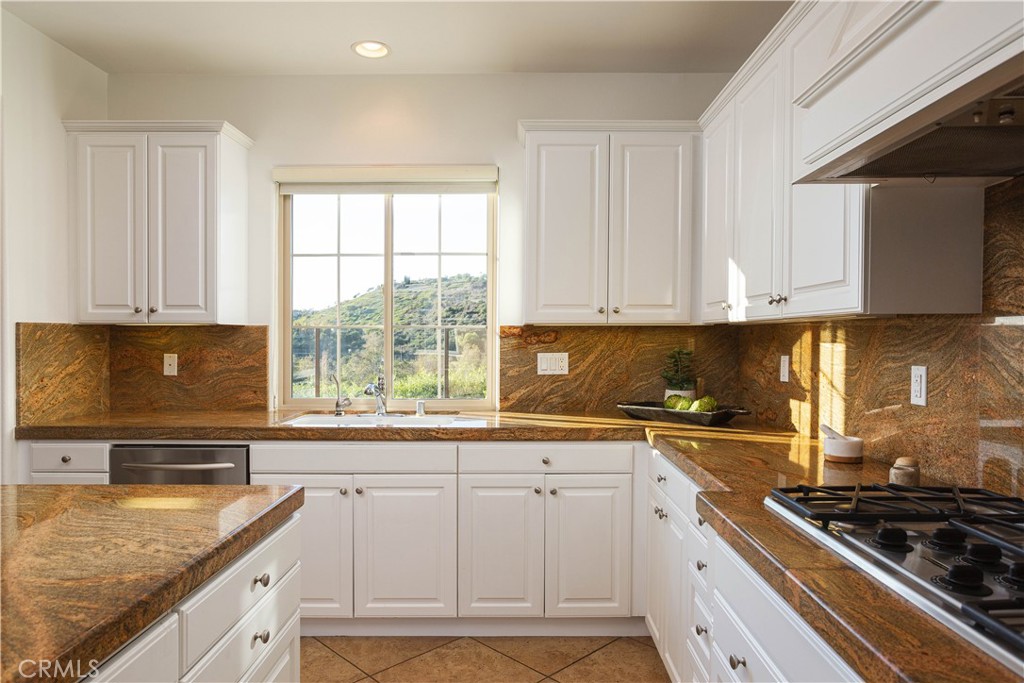 16 Via Elda San Clemente, CA 92673 - Photo 7 of 32 a kitchen with granite countertop a sink stove and cabinets