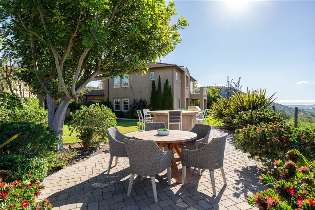 16 Via Elda San Clemente, CA 92673 - Photo 10 of 32 a view of a patio with a table and chairs potted plants and large tree