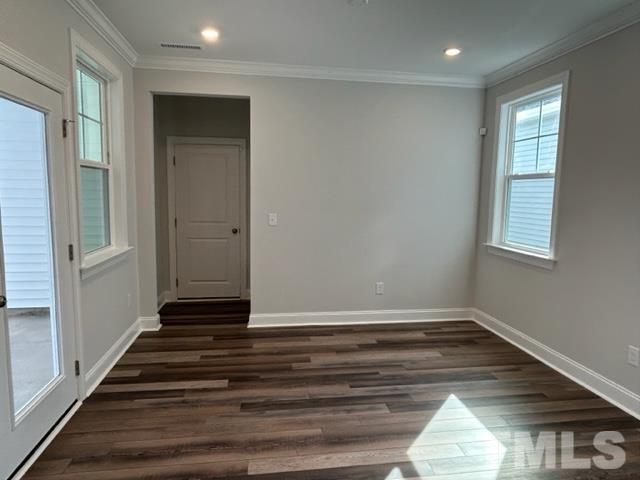 192 Edge Of Auburn Boulevard Raleigh, NC 27610 - Photo 14 of 44 a view of an empty room with wooden floor and a window