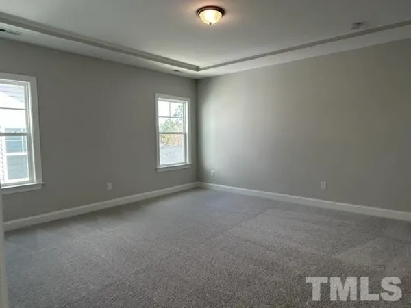 an empty room with windows and closet
