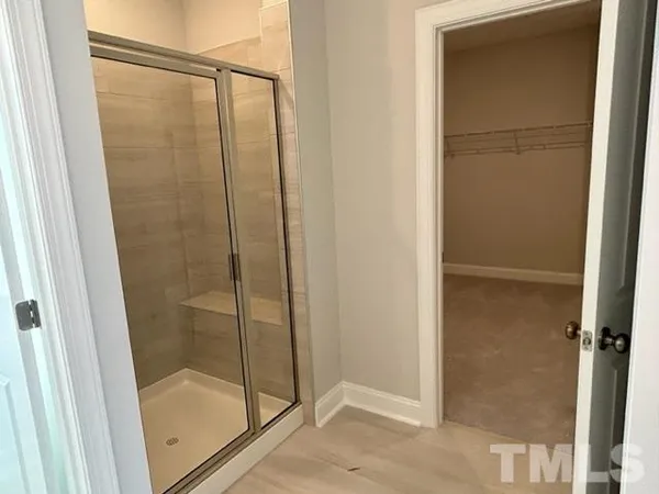a bathroom with a glass shower door