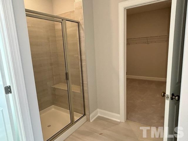 192 Edge Of Auburn Boulevard Raleigh, NC 27610 - Photo 22 of 44 a bathroom with a glass shower door