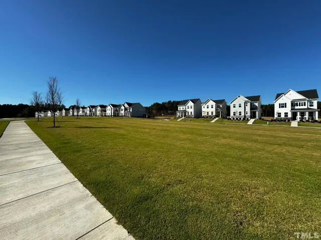 a view of a park with a building in the background