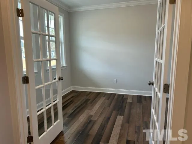 a view of an entryway with wooden floor and door