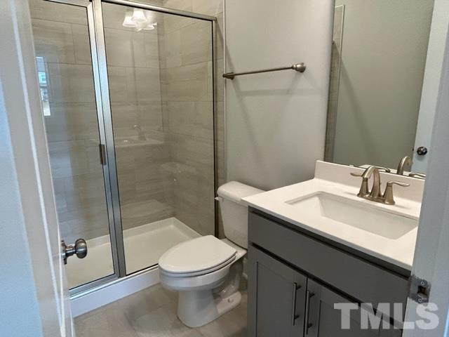 192 Edge Of Auburn Boulevard Raleigh, NC 27610 - Photo 5 of 44 a bathroom with a sink a toilet and shower