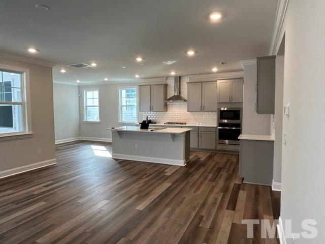 192 Edge Of Auburn Boulevard Raleigh, NC 27610 - Photo 7 of 44 a large kitchen with kitchen island a stove a sink and a refrigerator