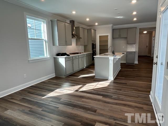 192 Edge Of Auburn Boulevard Raleigh, NC 27610 - Photo 9 of 44 a kitchen with a refrigerator and a sink