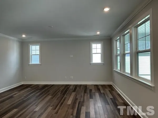 a view of wooden floor and windows in a room